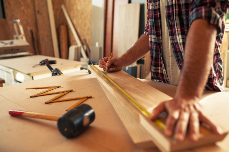 Carpenter doing his job in carpentry workshop
